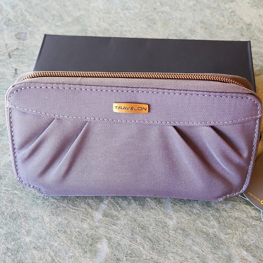 Wristlet by Travelon grey with purple lining lots of compartments cip on strap